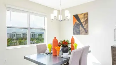 a dining room with a table and a window at Strategic Condo 2 Bd Close to Disney Storey Lake in Kissimmee