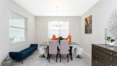 a kitchen with a dining room table and chairs at Strategic Condo 2 Bd Close to Disney Storey Lake in Kissimmee