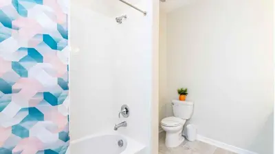 a bathroom with a toilet and a shower at Strategic Condo 2 Bd Close to Disney Storey Lake in Kissimmee