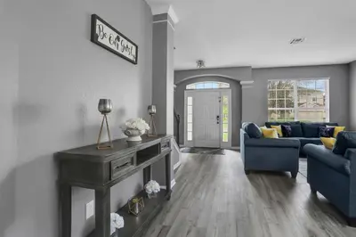 a living room with a couch and a table at Themed Luxury 6BR Getaway with Resort Amenities in Orlando