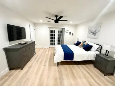 a bedroom with a bed and a ceiling fan at Superhost FREE Heated Pool 9 minutes to MCO 15 minutes to Disney in Kissimmee