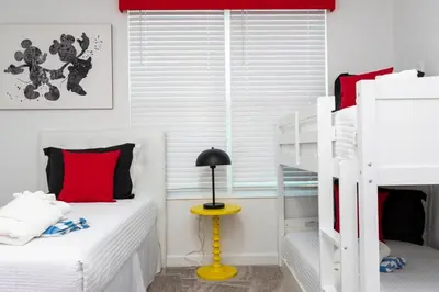 a bedroom with two bunk beds and a lamp at Spacious & Comfy Retreat Prime Location Amazing in Kissimmee