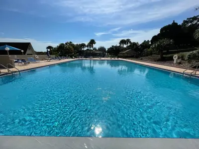 a large swimming pool with blue water at Watch the Sunrise on Lake Louisa in Clermont