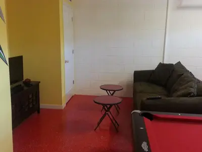 a living room with a couch and a table at Captain Jack's Getaway in Kissimmee