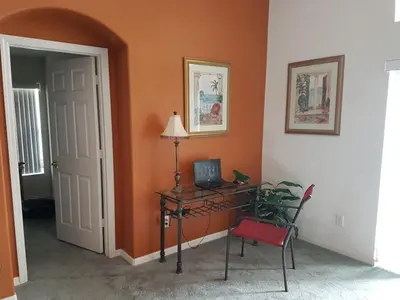 a room with a desk with a computer and a chair at Captain Jack's Getaway in Kissimmee