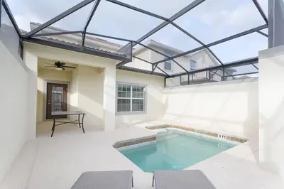 an indoor swimming pool with a glass roof at Stunning Storey Lake Villa Prime Location in Kissimmee