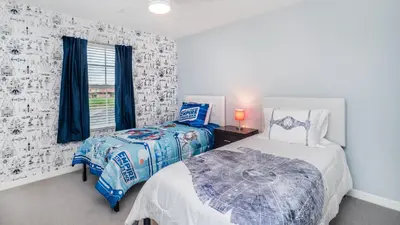 a bedroom with two beds and a window at Lake View 4 Bedroom Pool Home in Kissimmee