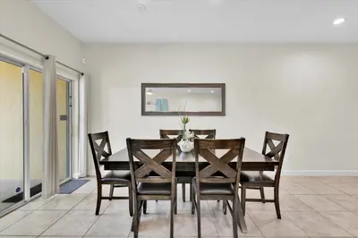 a dining room with a table and chairs at Lake View 4 Bedroom Pool Home in Kissimmee