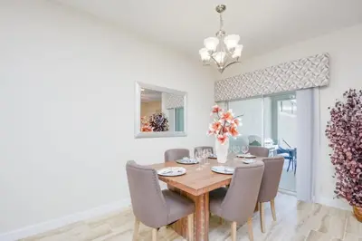 a dining room with a wooden table and chairs at Private Pool Prime Location Beautiful Home in Kissimmee