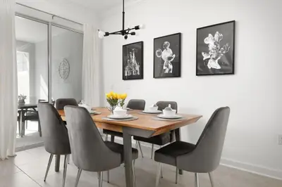 a dining room with a wooden table and chairs at Charming Mickey-Themed Home Prime Location in Kissimmee