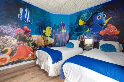 a room with two beds and an underwater mural at Luxury 4BR Home - Private Pool BBQ - Near Disney in Kissimmee