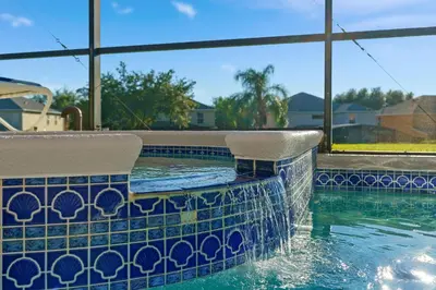 a swimming pool with a blue and white tiled pool at bsv_villa2633 in Kissimmee