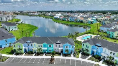an aerial view of a town with houses and a river at Surfstyle at Margaritaville by Shine Villas 022 villa in Orlando