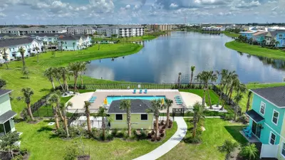 an aerial view of a body of water with houses at Surfstyle at Margaritaville by Shine Villas 022 villa in Orlando