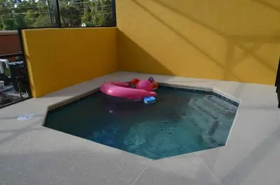 a small swimming pool with a pink raft in the water at 1320 - Aladin Cozy Bella Vida Kissimmee Close Disney in Kissimmee