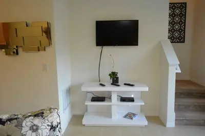 a living room with a tv on a wall at 1320 - Aladin Cozy Bella Vida Kissimmee Close Disney in Kissimmee