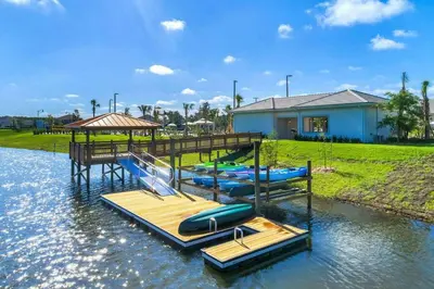 a group of inflatables on a dock in the water at Charming 4BR with Private Heated Pool & BBQ Grill in Kissimmee