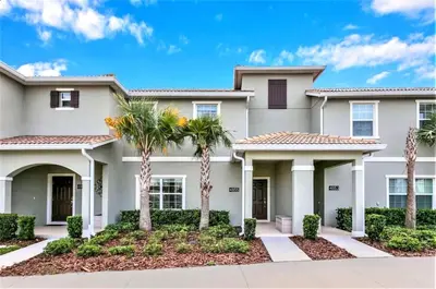 a house with palm trees in front of it at Charming 4BR with Private Heated Pool & BBQ Grill in Kissimmee