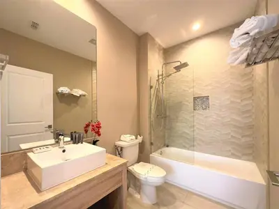 a bathroom with a sink and a toilet and a shower at Elegant Home w 3 En Suites & Breathtaking View in Orlando