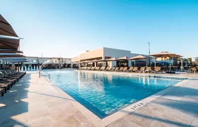 a large swimming pool with chairs and umbrellas at Elegant Home w 3 En Suites & Breathtaking View in Orlando