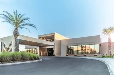 a large building with palm trees in front of it at Elegant Home w 3 En Suites & Breathtaking View in Orlando