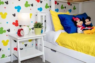 a bedroom with mickey mouse decals on the wall at Stunning 5BR Home - Your Dream Getaway in Kissimmee