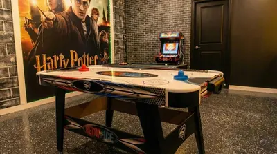 a ping pong table in a room with a video game at Stunning 5BR Home - Your Dream Getaway in Kissimmee