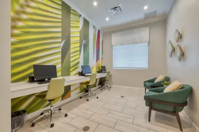an office with chairs and a desk with a computer at Chic Retreat - Unforgettable Stay in Kissimmee