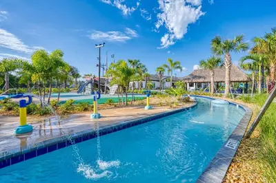 a pool at a resort with palm trees at Chic Retreat - Unforgettable Stay in Kissimmee