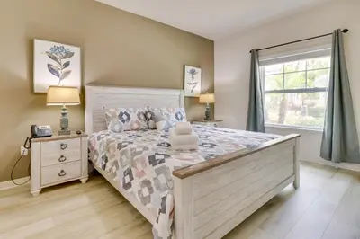 a bedroom with a large bed and a window at New Home Close To Disney Bliss! in Kissimmee