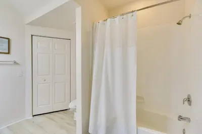 a white shower curtain in a bathroom with a toilet at New Home Close To Disney Bliss! in Kissimmee