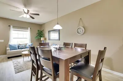 a dining room and living room with a table and chairs at New Home Close To Disney Bliss! in Kissimmee