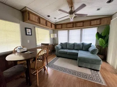 a living room with a couch and a table at 15 min to Disney World, Self-check-in, Full Kitchen in Kissimmee