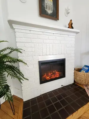 a white brick fireplace with a fire place at Cozy Vintage Bungalow @Mills50 District in Orlando