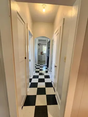 a hallway with a black and white checkered floor at Cozy Vintage Bungalow @Mills50 District in Orlando