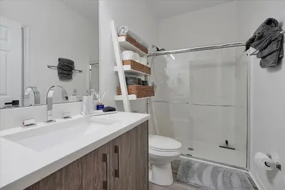 a bathroom with a sink and a shower and a toilet at Magical Serenity in Orlando