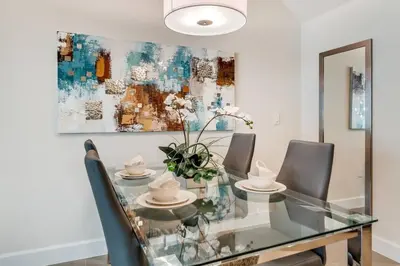 a dining room with a glass table and chairs at Ultimate Getaway - Your Best Vacation Home in Orlando