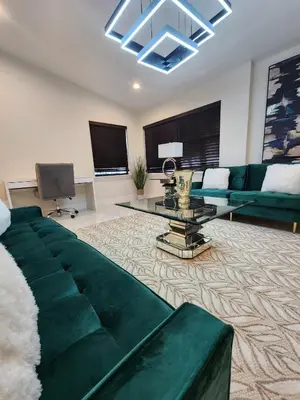 a living room with a green couch and a table at The Villa Orlando College Park Sleeps16 - Monthly Stays in Orlando