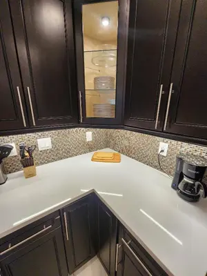 a kitchen with black cabinets and a counter top at The Villa Orlando College Park Sleeps16 - Monthly Stays in Orlando