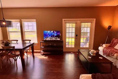 a living room with a table and a tv in it at ABC Vacation Homes in Kissimmee