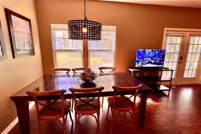 a dining room with a wooden table and chairs at ABC Vacation Homes in Kissimmee