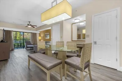 a dining room with a glass table and chairs at Cozy Orlando Resort Condo 4Mi from Disney in Orlando