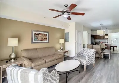 a living room with a couch and a ceiling fan at Cozy Orlando Resort Condo 4Mi from Disney in Orlando