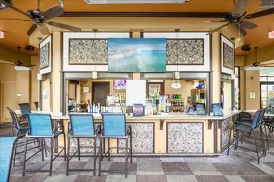 a bar with chairs in front of a store at Cozy Orlando Resort Condo 4Mi from Disney in Orlando