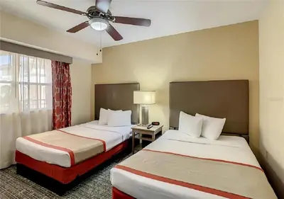 a hotel room with two beds and a ceiling fan at Cozy Orlando Resort Condo 4Mi from Disney in Orlando