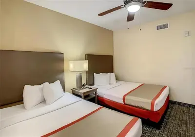 a hotel room with two beds and a ceiling fan at Cozy Orlando Resort Condo 4Mi from Disney in Orlando