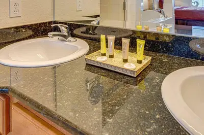 a bathroom with a sink and a counter top with a sink at Exquisite 3 Bdr Condo Minutes to Disney in Orlando