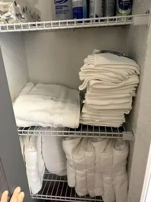 a closet filled with lots of white towels at 3brdrm home near Downtown Orlando and Winterpark in Orlando
