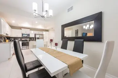 a kitchen and dining room with a table and chairs at Apartment 3BR Great Location - Super Comfort in Kissimmee