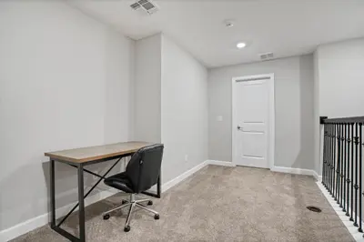 an empty office with a desk and a chair at New Home 8 Bedrooms and 5 Bathrooms At Storey Lake in Kissimmee